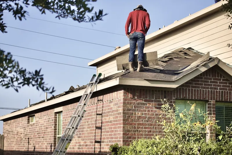 Professional roofer working on a residential roof in Prineville